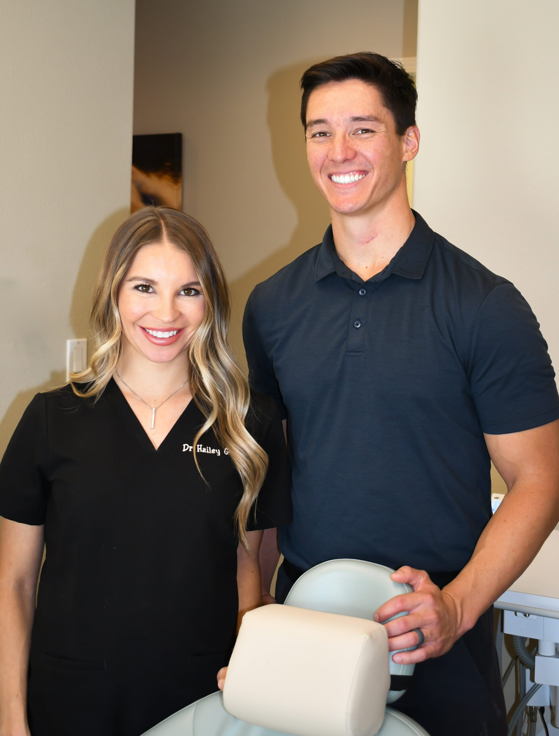 A family stands on a wooden dock by a serene pond, surrounded by lush greenery and soft sunlight, enjoying a peaceful moment together.